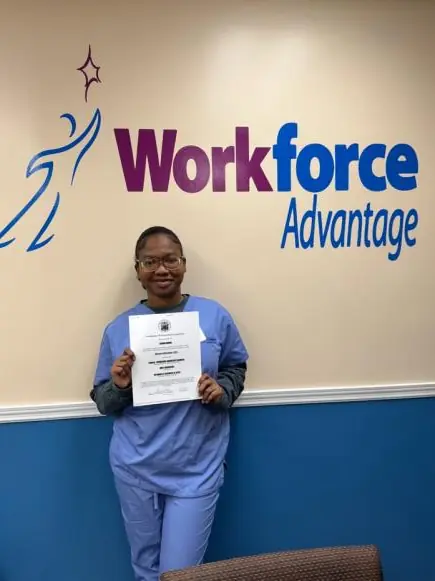 Carina Normil holding her CNA training certificate at WorkForce Advantage