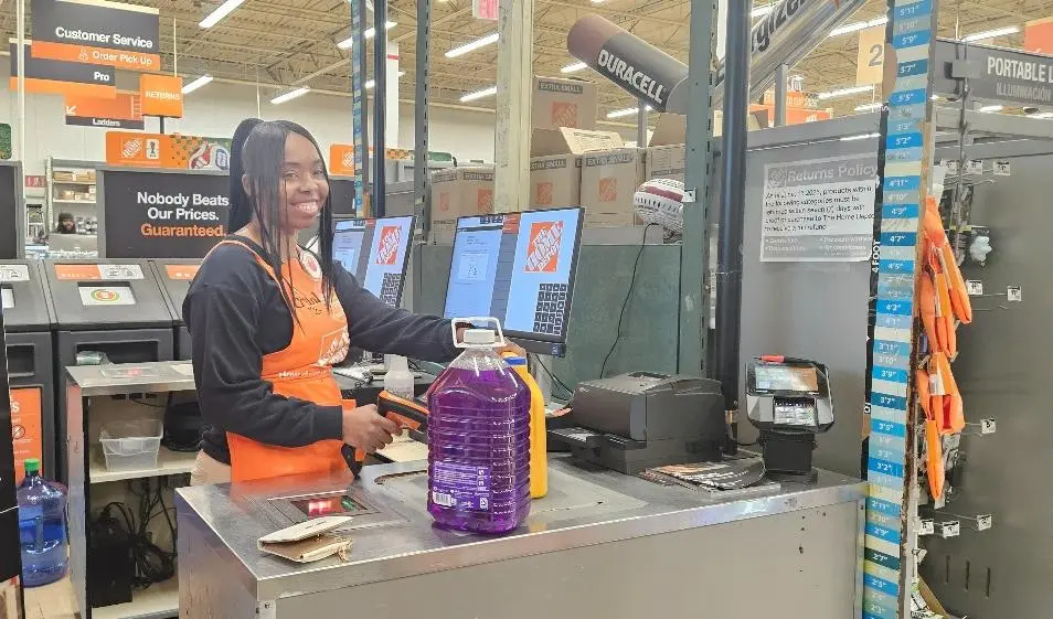 Crystal Beverly assisting customers at a Home Depot checkout station